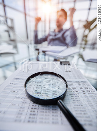 Photo magnifier with graphs and figures in the tables Photo magnifier with graphs and figures in the tables 123616596