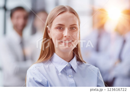 Confident woman posing in front of his colleague during a meeting 123616722