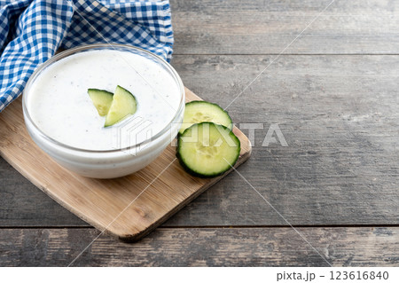Greek Tzatziki sauce in bowl on wooden table Greek Tzatziki sauce in bowl on wooden table 123616840