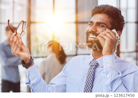 professional businessman executive entrepreneur wearing holding telephone making corporate call on cellphone. professional businessman executive entrepreneur wearing holding telephone making corporate call on cellphone. 123617450
