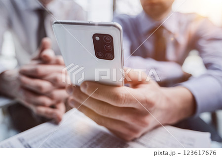 Close up of young business man using mobile smart phone 123617676