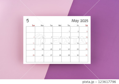 May 2025 calendar page on purple two tone color background. 123617796