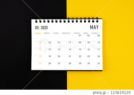 May 2025 desk calendar on black and yellow background, Flat lay. 123618120