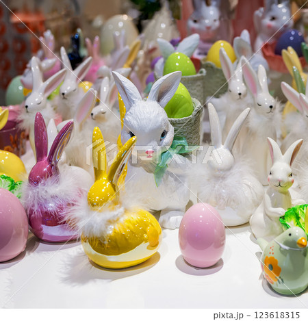 Decorative Easter rabbits with pastel colored eggs, fluffy accents. Easter display featuring charming bunnies and colorful eggs. Festive springtime display filled with charm and warmth Decorative Easter rabbits with pastel colored eggs, fluffy accents. Easter display featuring charming bunnies and colorful eggs. Festive springtime display filled with charm and warmth 123618315