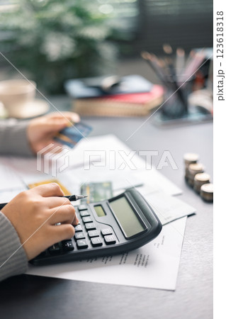 Finance bank tax expense accounting budget money businessman hand use calculator Financial calculate accountant close up calculator with graph chart write office desk Business expense analysis saving 123618318
