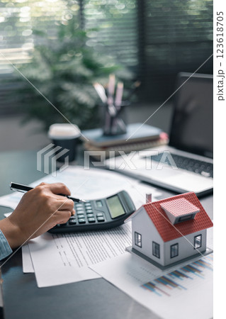 Finance bank tax expense accounting budget money businessman home for Business expense analysis saving use Financial calculate accountant close up calculator with graph chart hand write office desk 123618705