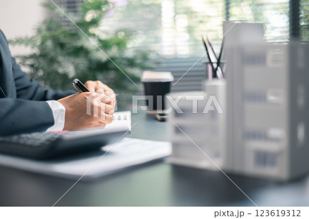 Finance bank tax expense accounting budget money businessman home for Business expense analysis saving use Financial calculate accountant close up calculator with graph chart hand write office desk 123619312