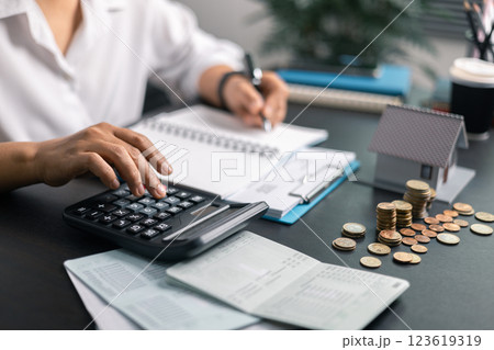 Finance bank tax expense accounting budget money businessman home for Business expense analysis saving use Financial calculate accountant close up calculator with graph chart hand write office desk 123619319