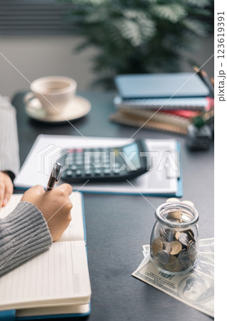 Finance bank tax expense accounting budget money businessman hand use calculator Financial calculate accountant close up calculator with graph chart write office desk Business expense analysis saving 123619391