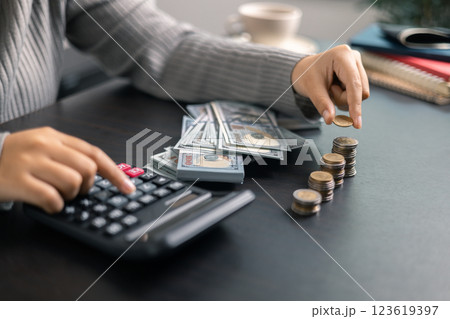 Finance bank tax expense accounting budget money businessman hand use calculator Financial calculate accountant close up calculator with graph chart write office desk Business expense analysis saving 123619397