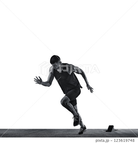Concentrated and focused young man, dressed sportwear, running quickly from start against white background. Black and white photo. Concentrated and focused young man, dressed sportwear, running quickly from start against white background. Black and white photo. 123619748