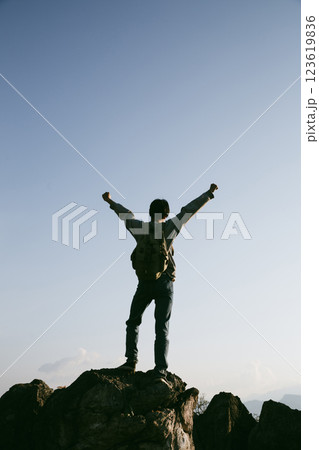 Man traveler with camera backpack hiking outdoor travel lifestyle and adventure concept. cap backpack and join of tourist for green mountain tour, beauty of nature and expansive sky people of tourism Man traveler with camera backpack hiking outdoor travel lifestyle and adventure concept. cap backpack and join of tourist for green mountain tour, beauty of nature and expansive sky people of tourism 123619836