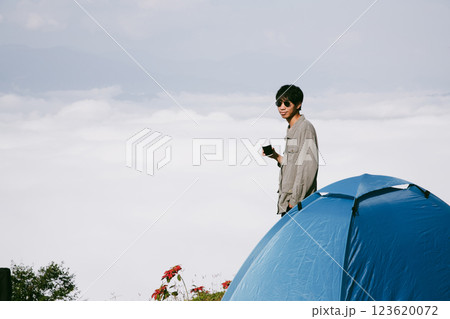 Man traveler with camera backpack hiking outdoor travel lifestyle and adventure concept. cap backpack and join of tourist for green mountain tour, beauty of nature and expansive sky people of tourism 123620072