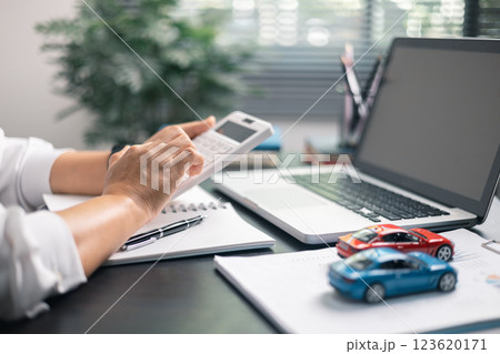 Finance bank tax expense accounting budget money businessman hand for Business expense analysis saving use car Financial calculate accountant close up calculator with graph chart write office desk 123620171