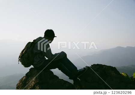 Man traveler with camera backpack hiking outdoor travel lifestyle and adventure concept. cap backpack and join of tourist for green mountain tour, beauty of nature and expansive sky people of tourism Man traveler with camera backpack hiking outdoor travel lifestyle and adventure concept. cap backpack and join of tourist for green mountain tour, beauty of nature and expansive sky people of tourism 123620296