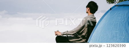 Man traveler with backpack hiking outdoor travel lifestyle and adventure concept. join of tourist for green mountain tour beauty of nature and expansive sky people of tourism. banner with copy space Man traveler with backpack hiking outdoor travel lifestyle and adventure concept. join of tourist for green mountain tour beauty of nature and expansive sky people of tourism. banner with copy space 123620390