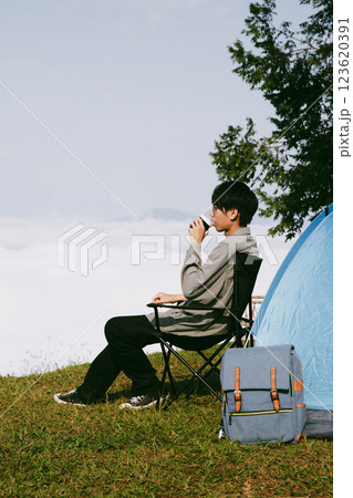 Man traveler with camera backpack hiking outdoor travel lifestyle and adventure concept. cap backpack and join of tourist for green mountain tour, beauty of nature and expansive sky people of tourism 123620391