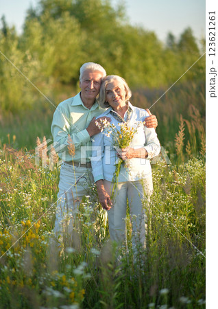 Loving mature couple in the park in summer Loving mature couple in the park in summer 123621261