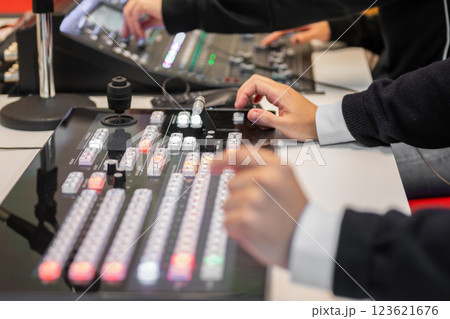 Video editor working with footage using modern video editing software and hardware control panel Video editor working with footage using modern video editing software and hardware control panel 123621676