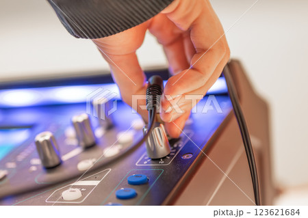 Sound engineer using digital audio mixer sliders Engineer pressing keys adds control panel volume Sound engineer using digital audio mixer sliders Engineer pressing keys adds control panel volume 123621684