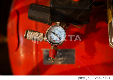 Close-up View of Pressure Gauge on Industrial Air Compressor on Red Tank Background Close-up View of Pressure Gauge on Industrial Air Compressor on Red Tank Background 123623494