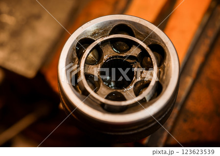 Close-up View of Industrial Mechanical Gear Component with Lubricant Oil on Metal Surface Close-up View of Industrial Mechanical Gear Component with Lubricant Oil on Metal Surface 123623539