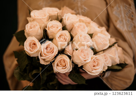 Elegant Bouquet of Cream Roses Held by Person in Traditional Attire Elegant Bouquet of Cream Roses Held by Person in Traditional Attire 123623611