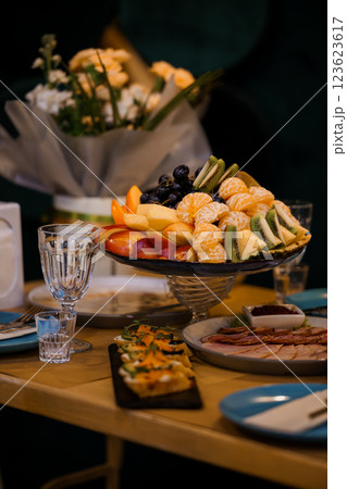 Vibrant Fruit and Culinary Delight Display at an Elegant Table Setting 123623617