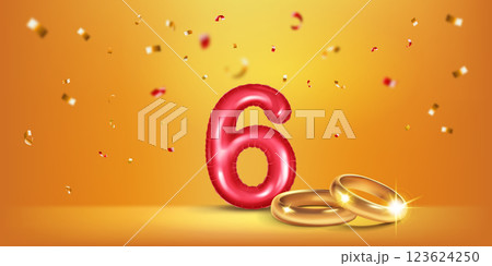 Red number 6, gold wedding rings and confetti. 123624250