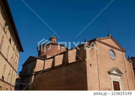 Historic brick church facade with clear sky and architectural details 123625149