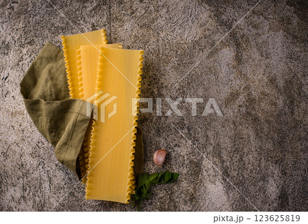 Uncooked lasagna pasta with cooking ingredient Uncooked lasagna pasta with cooking ingredient 123625819