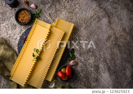 Uncooked lasagna pasta with cooking ingredient Uncooked lasagna pasta with cooking ingredient 123625823