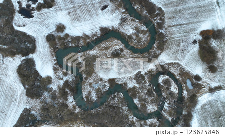 Inland river winter snow delta river ice frost meanders drone aerial freezing shot in floodplain forest lowlands wetland swamp, quadcopter view, protected landscape area Ltovelske Pomoravi Europe Inland river winter snow delta river ice frost meanders drone aerial freezing shot in floodplain forest lowlands wetland swamp, quadcopter view, protected landscape area Ltovelske Pomoravi Europe 123625846