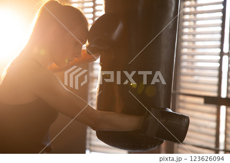Women self defense girl power. Strong woman fighter resting after fight training on boxing ring. Strong girl tired after punching boxing bag. Training day in gym. Strength fit body workout training Women self defense girl power. Strong woman fighter resting after fight training on boxing ring. Strong girl tired after punching boxing bag. Training day in gym. Strength fit body workout training 123626094