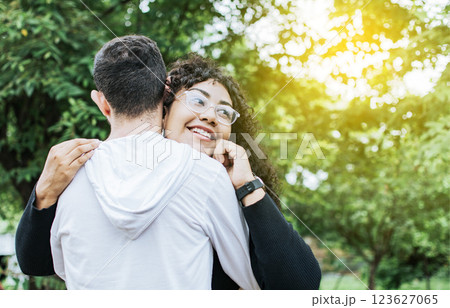 Teenage couple hugging outdoors, Close up of happy couple hugging in nature, Close up of smiling teenage couple hugging Teenage couple hugging outdoors, Close up of happy couple hugging in nature, Close up of smiling teenage couple hugging 123627065