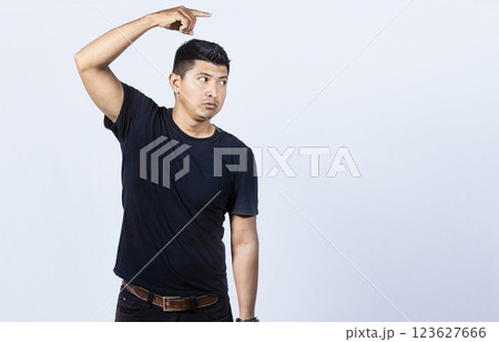 Surprised handsome man pointing to the side, Surprised guy pointing a poster, Concept of latin man pointing a banner to the side Surprised handsome man pointing to the side, Surprised guy pointing a poster, Concept of latin man pointing a banner to the side 123627666