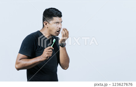 Person with brush with bad breath problem, Man with brush and bad breath, Concept of person with halitosis 123627676