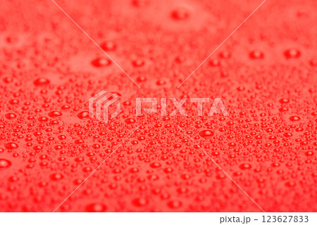 Red plastic with water drops macro photo. Abstract red background with drops. Red plastic with water drops macro photo. Abstract red background with drops. 123627833