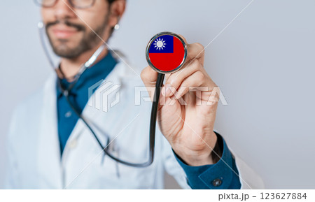 Doctor holding stethoscope with Taiwan flag. Taiwan health and care concept, Taiwan flag on stethoscope 123627884
