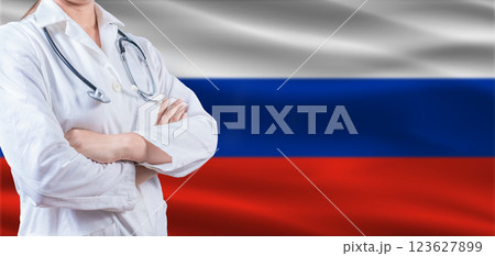Doctor With Crossed Arms On Russian Flag. Russia Health And Care Concept. Female Doctor On Russian Flag 123627899