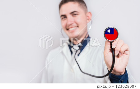Young doctor showing stethoscope with Taiwan flag. Taiwan national healthcare concept 123628007