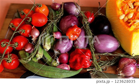 Colorful assortment of vegetables including orange pumpkin, red tomatoes, and purple onions symbolizes organic lifestyle. Eco arrangement highlights natural abundance in eco-friendly setting. 123628035