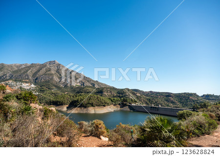 Scenic reservoir in mountainous landscape under clear blue sky, La Concepcion reservoir in Marbella 123628824