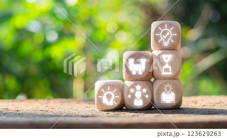 Wooden blocks with icons symbolizing success and achievement, set against a natural background, inspire motivation and results. Wooden blocks with icons symbolizing success and achievement, set against a natural background, inspire motivation and results. 123629263