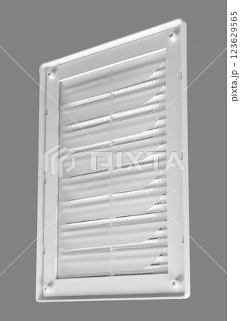 White ventilation grate on a gray background. Rectangular shape, plastic material. Back side with mesh. White ventilation grate on a gray background. Rectangular shape, plastic material. Back side with mesh. 123629565