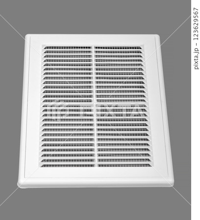 White ventilation grate on a gray background. Rectangular shape, plastic material. White ventilation grate on a gray background. Rectangular shape, plastic material. 123629567