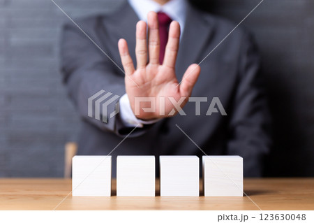 4つの白い木のブロックと拒絶ポーズをするミドル男性ビジネスマン 4つの白い木のブロックと拒絶ポーズをするミドル男性ビジネスマン 123630048