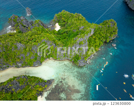 Boats and kayaks over the clear water. Lagoons in Miniloc Island. El Nido, Palawan. Philippines. 123630800