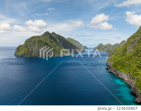 Tapiutan and Matinloc, Islands with blue sea. Blue sky and clouds. El Nido, Philippines. Tapiutan and Matinloc, Islands with blue sea. Blue sky and clouds. El Nido, Philippines. 123630807