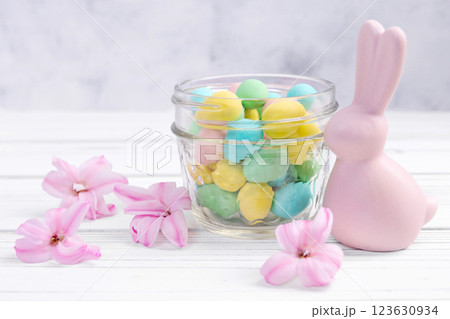Easter bunny, jar with sweet eggs and hyacinth flowers. Easter bunny, jar with sweet eggs and hyacinth flowers. 123630934